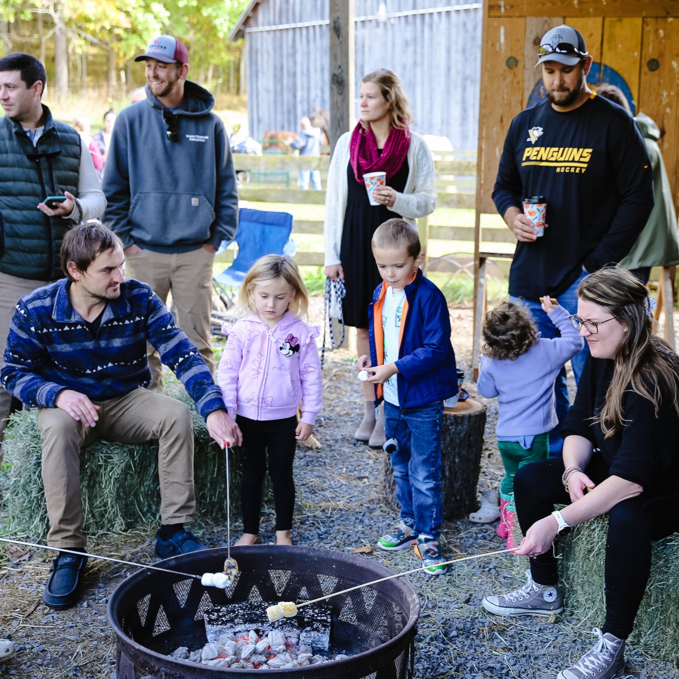 a group of people gathered around a fireplace in community.