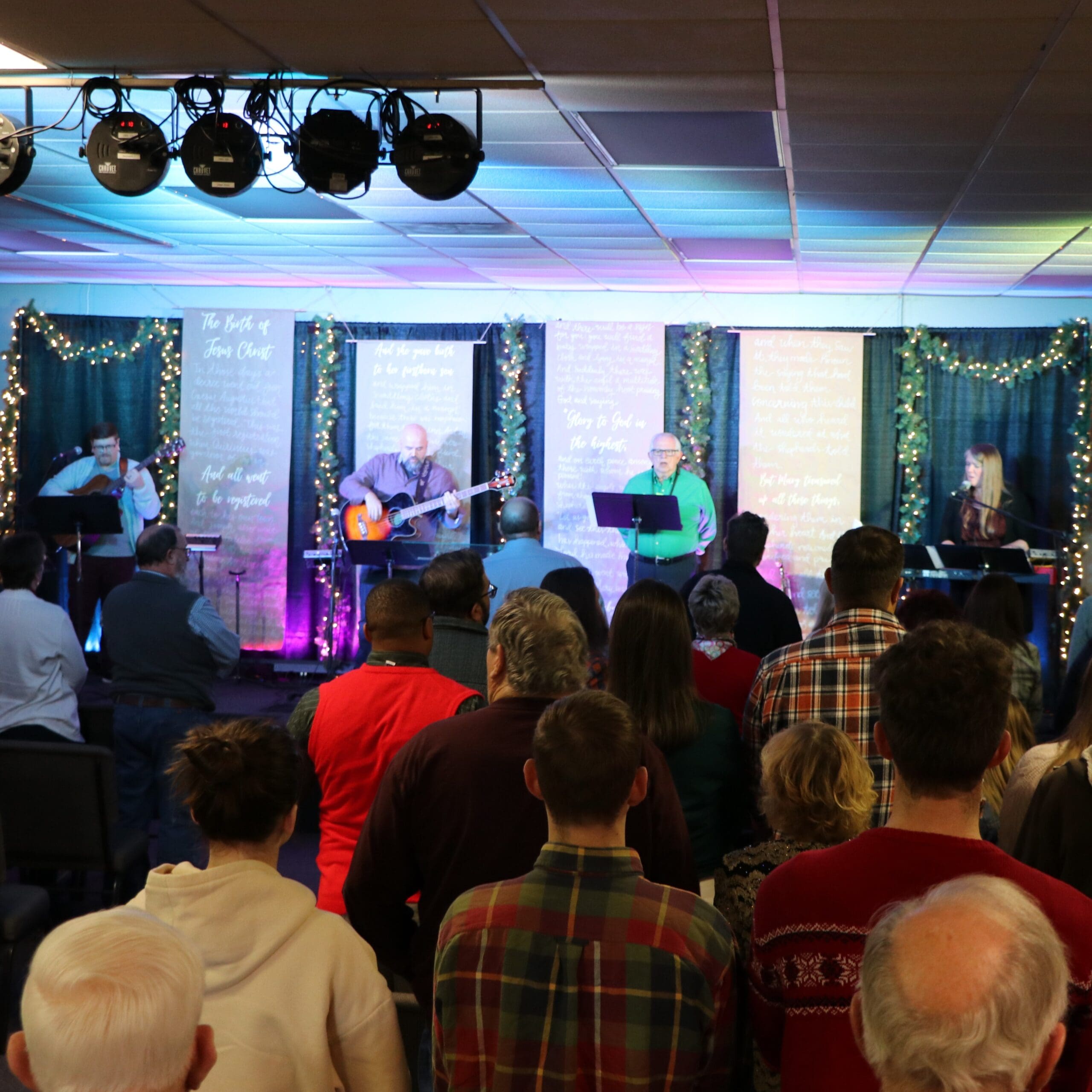 group of people listening to live music at the church