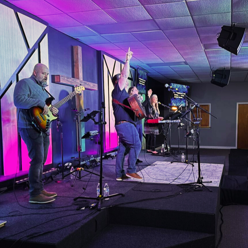 group of people listening to live music at the church